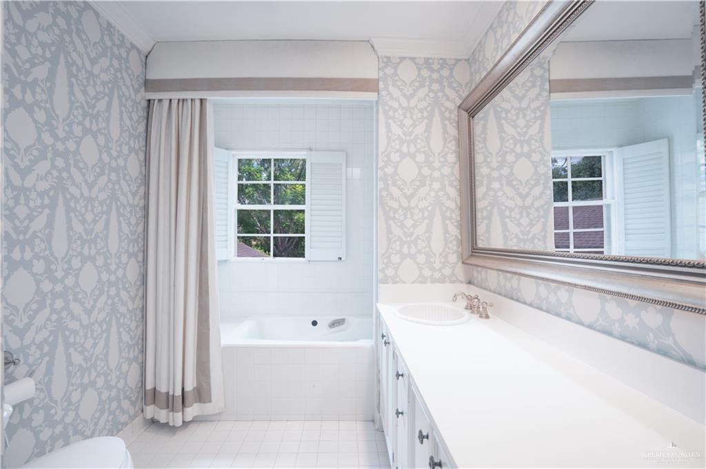 1131 West 6th Street Weslaco, TX 78596 - Photo 19 of 45 a bathroom with a bathtub and a window
