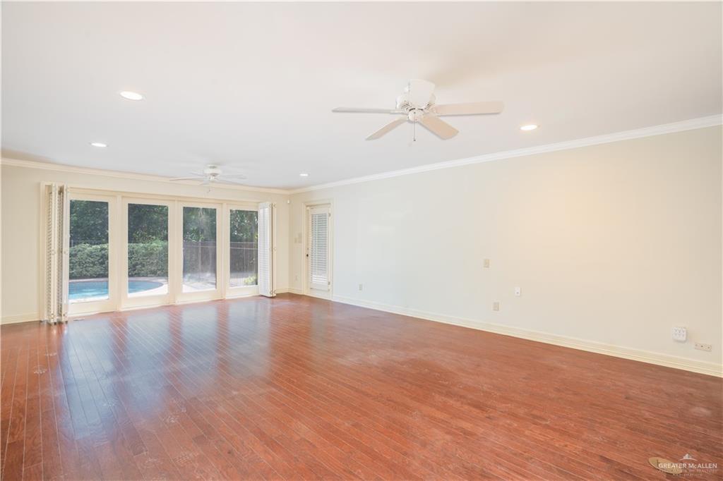1131 West 6th Street Weslaco, TX 78596 - Photo 9 of 45 wooden floor in an empty room with a window