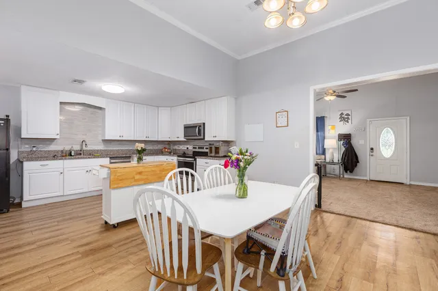 a view of a dining room with furniture and wooden floor