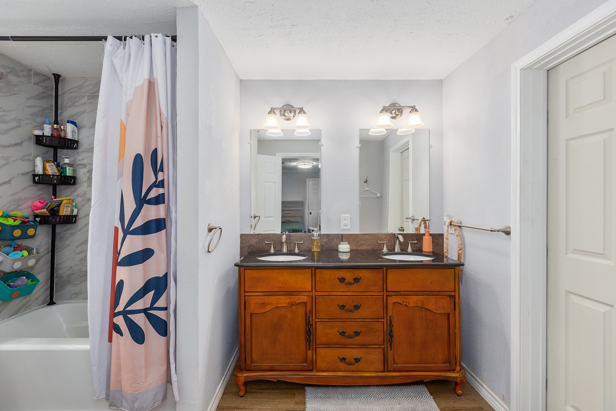 240 North 7th Street Trinity, TX 75862 - Photo 25 of 32 a bathroom with a granite countertop sink a mirror and a shower