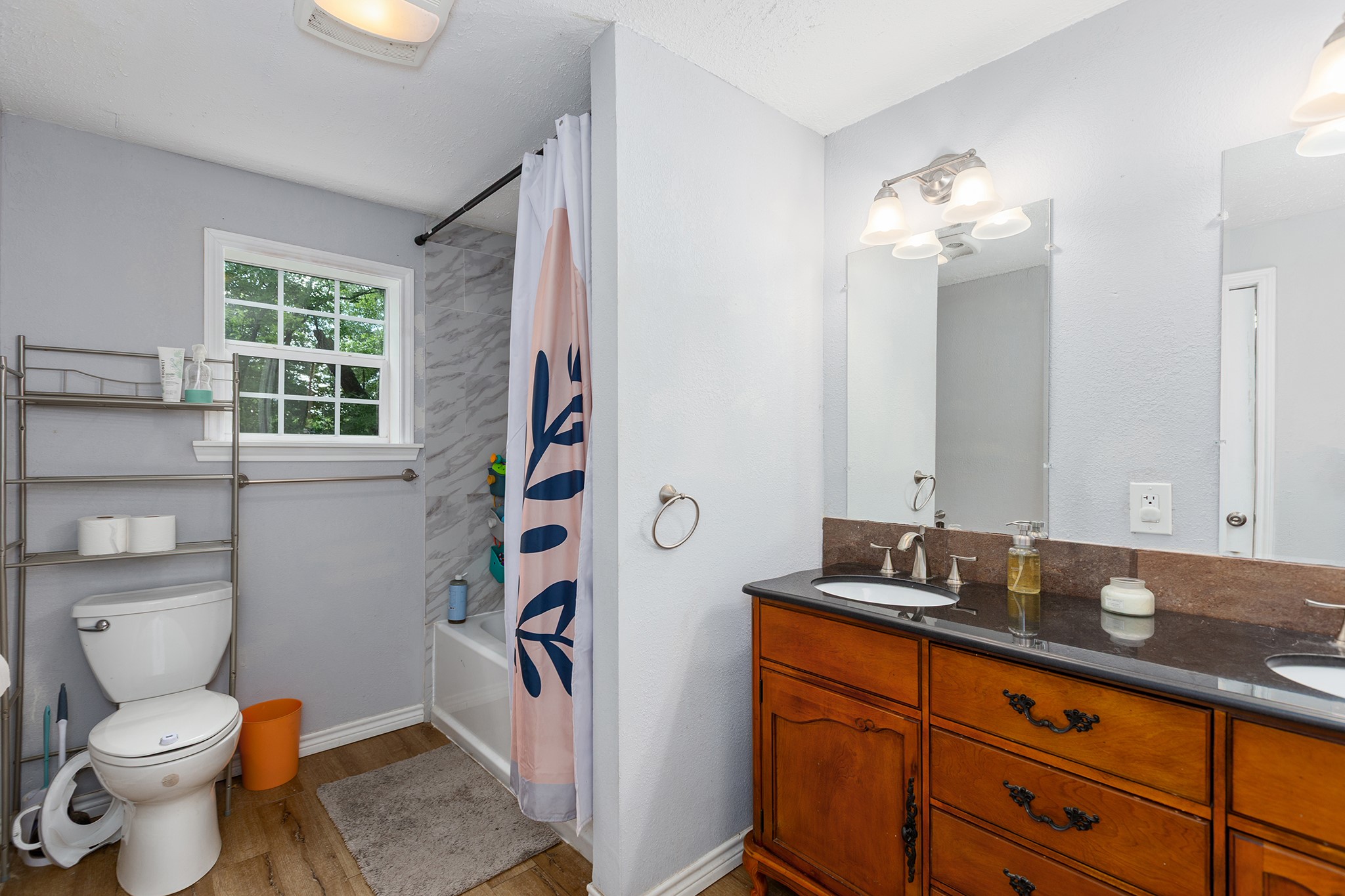 240 North 7th Street Trinity, TX 75862 - Photo 26 of 32 a bathroom with a granite countertop toilet sink and mirror