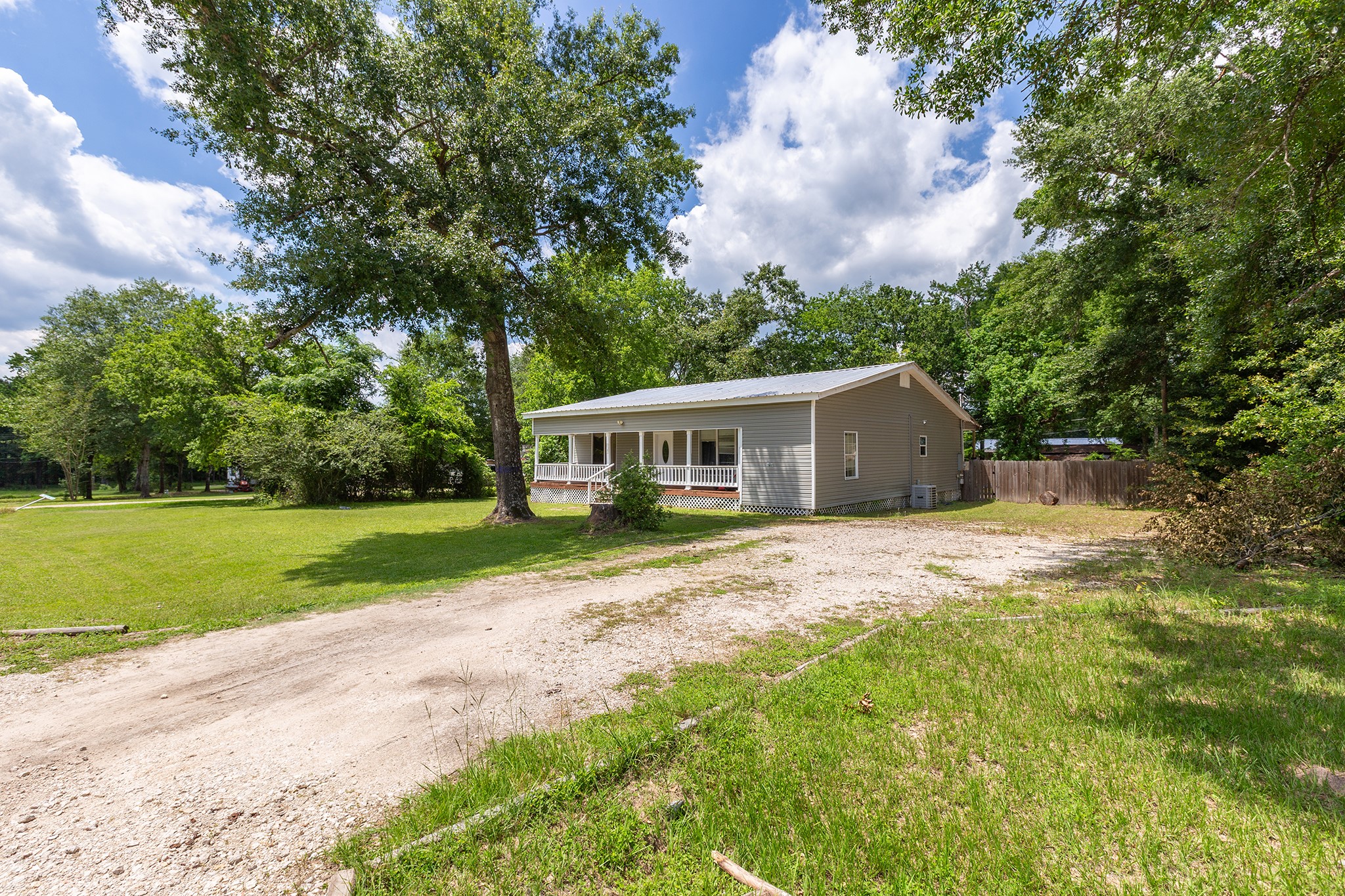 240 North 7th Street Trinity, TX 75862 - Photo 3 of 32 a front view of a house with yard and green space