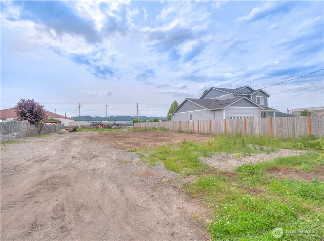 a backyard of a house with lots of green space table and chairs