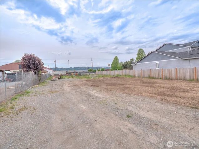 a backyard of a house with table and chairs