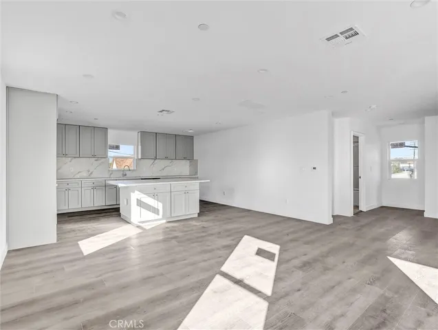 a kitchen with granite countertop a sink and cabinets