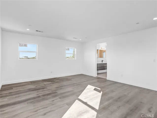 a bathroom with a tub a sink and a mirror