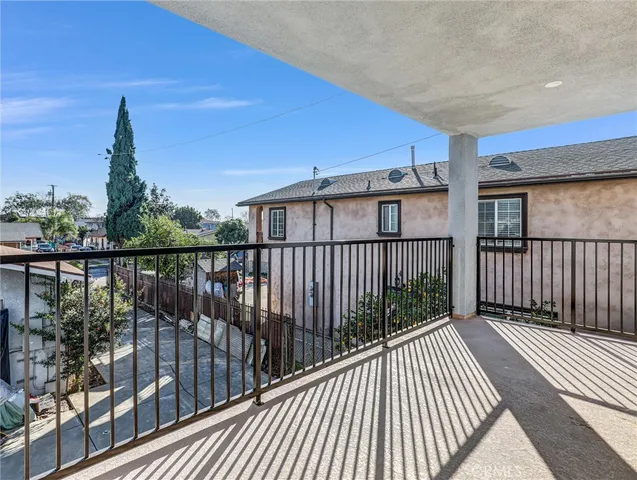 a view of a balcony with wooden floor and city view