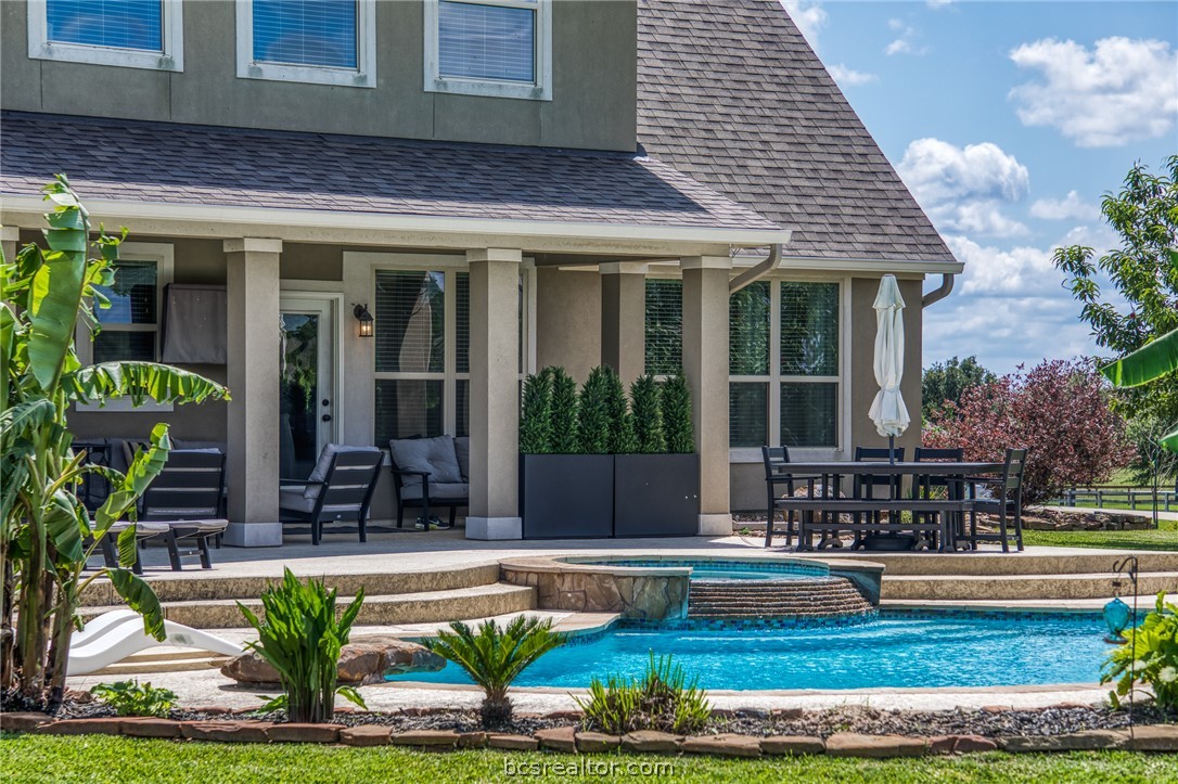 586 Ruby Drive Bellville, TX 77418 - Photo 36 of 50 a view of a house with a fountain in a patio