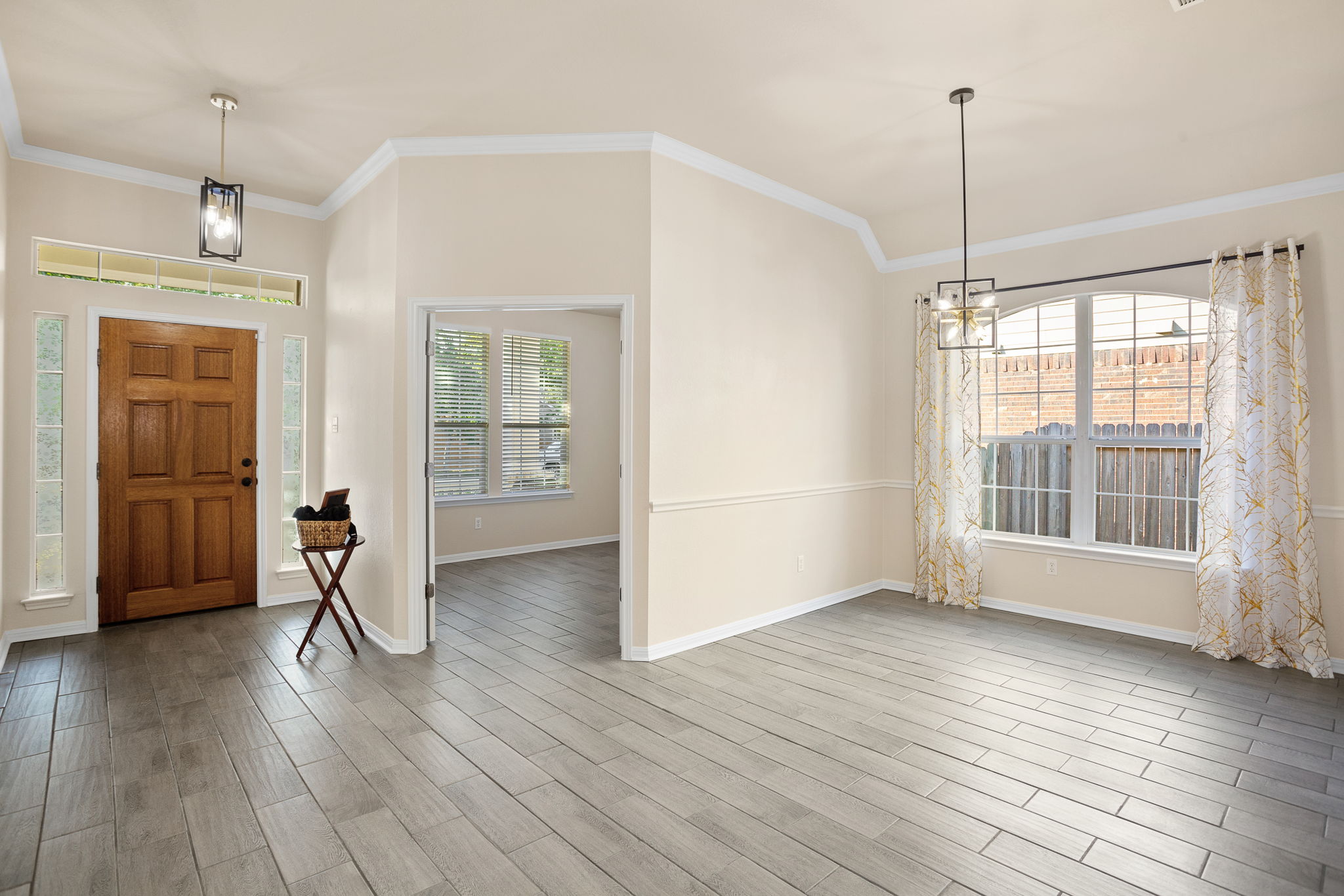 313 Greenside Lane Georgetown, TX 78633 - Photo 14 of 40 Entryway featuring crown molding, hanging lights, and wood tiled floors
