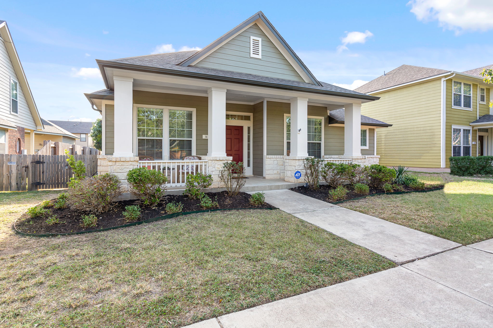 313 Greenside Lane Georgetown, TX 78633 - Photo 2 of 40 View of front of house featuring stone siding, a porch, and roof with shingles