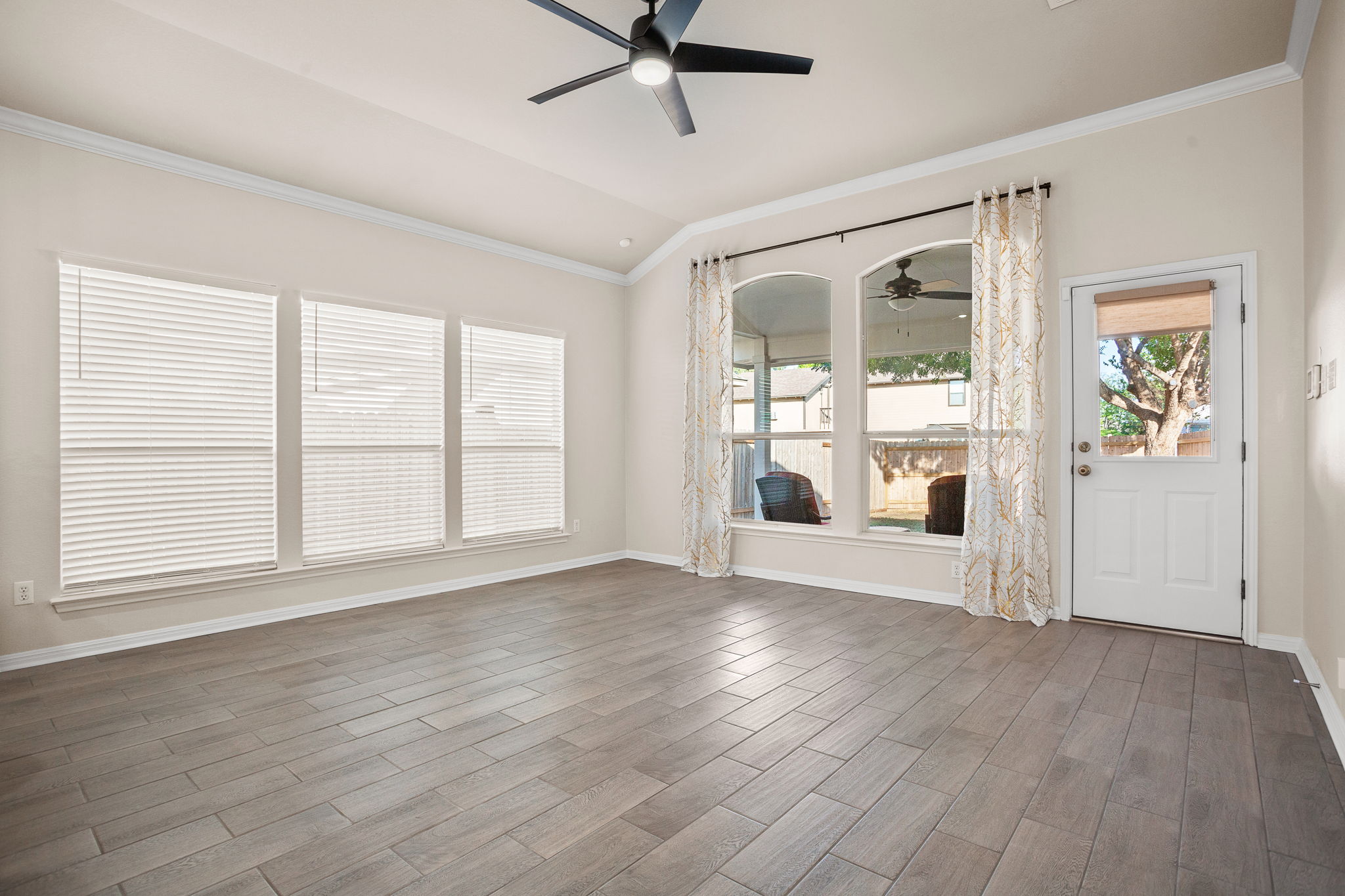 313 Greenside Lane Georgetown, TX 78633 - Photo 23 of 40 Spare room with ornamental molding, ceiling fan, wood tiled floors, and lofted ceiling