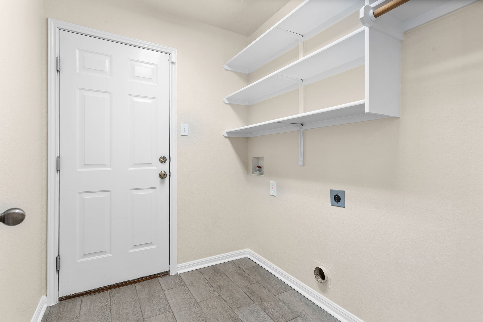 313 Greenside Lane Georgetown, TX 78633 - Photo 24 of 40 Laundry room featuring wood tiled floors, hookup for a washing machine, and electric dryer hookup