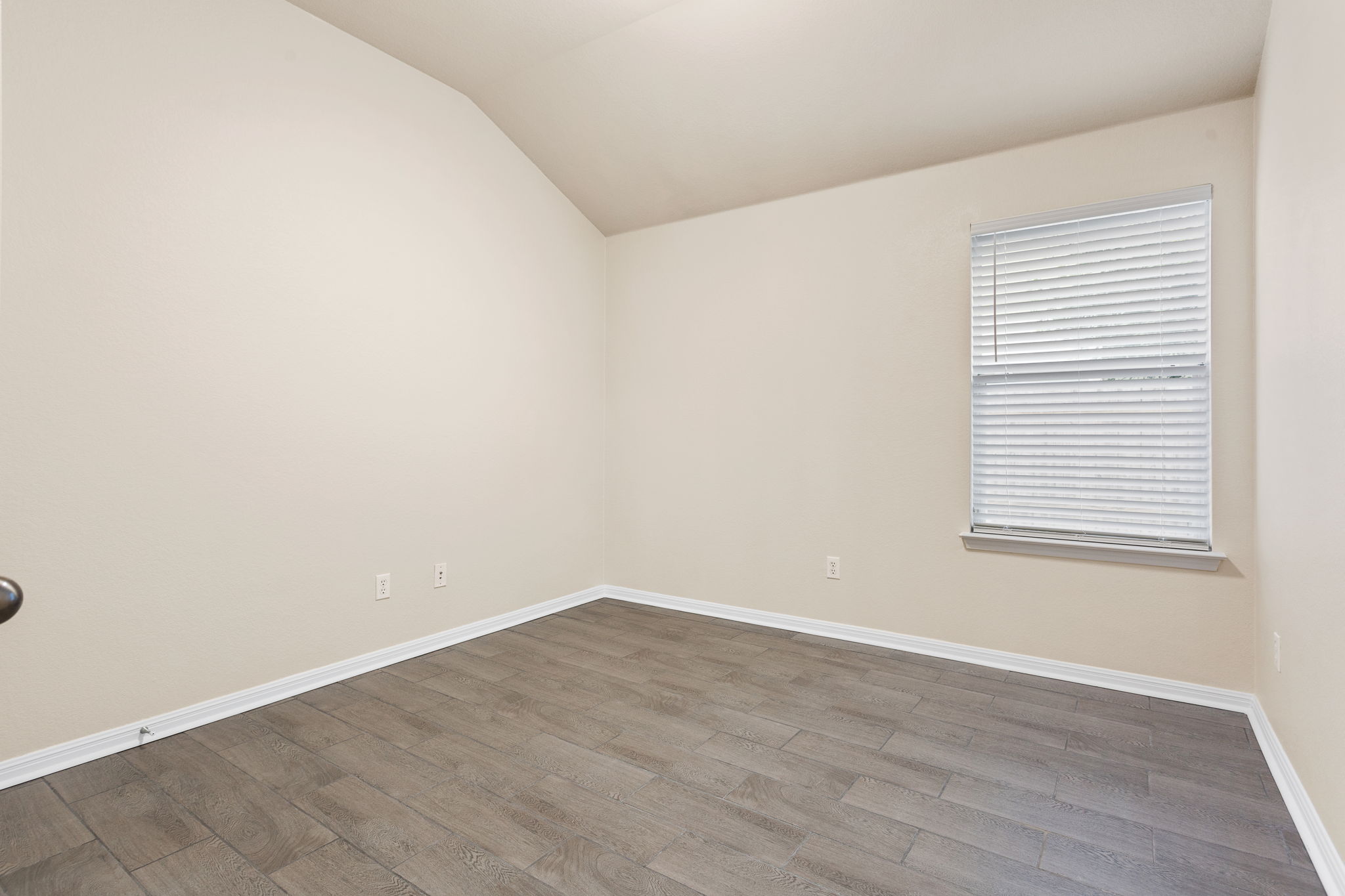 313 Greenside Lane Georgetown, TX 78633 - Photo 27 of 40 Empty room featuring vaulted ceiling and dark wood-style flooring