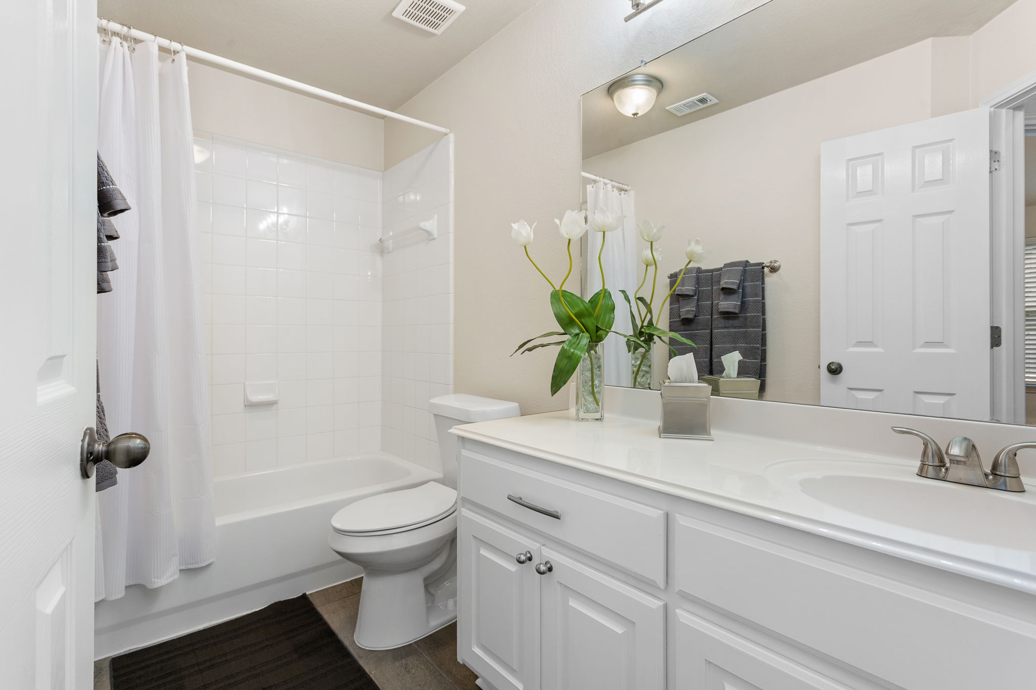 313 Greenside Lane Georgetown, TX 78633 - Photo 31 of 40 Bathroom with vanity, shower / tub combo with curtain, and dark wood-style floors