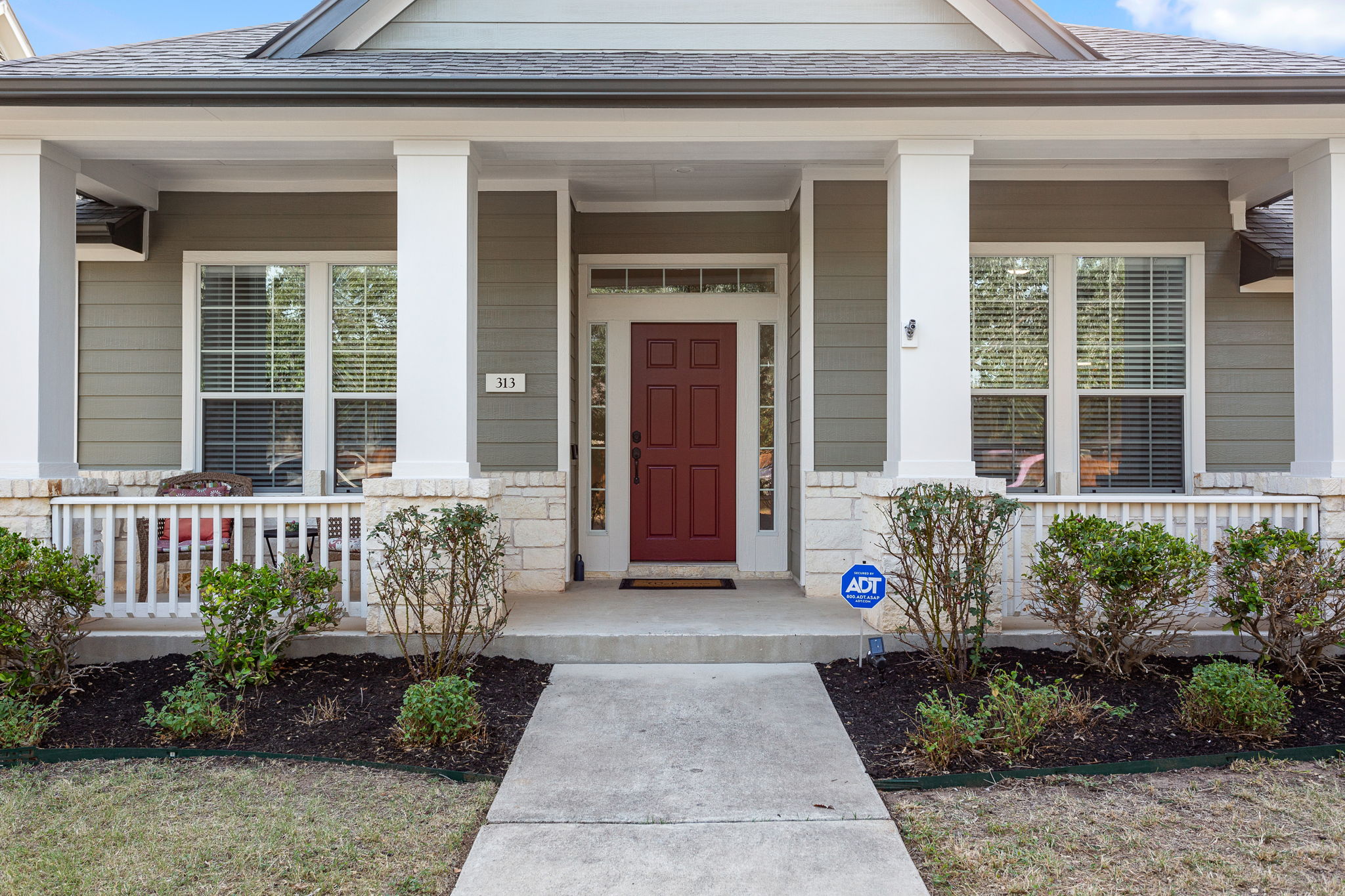 313 Greenside Lane Georgetown, TX 78633 - Photo 5 of 40 Property entrance featuring a porch, roof with shingles, and stone siding