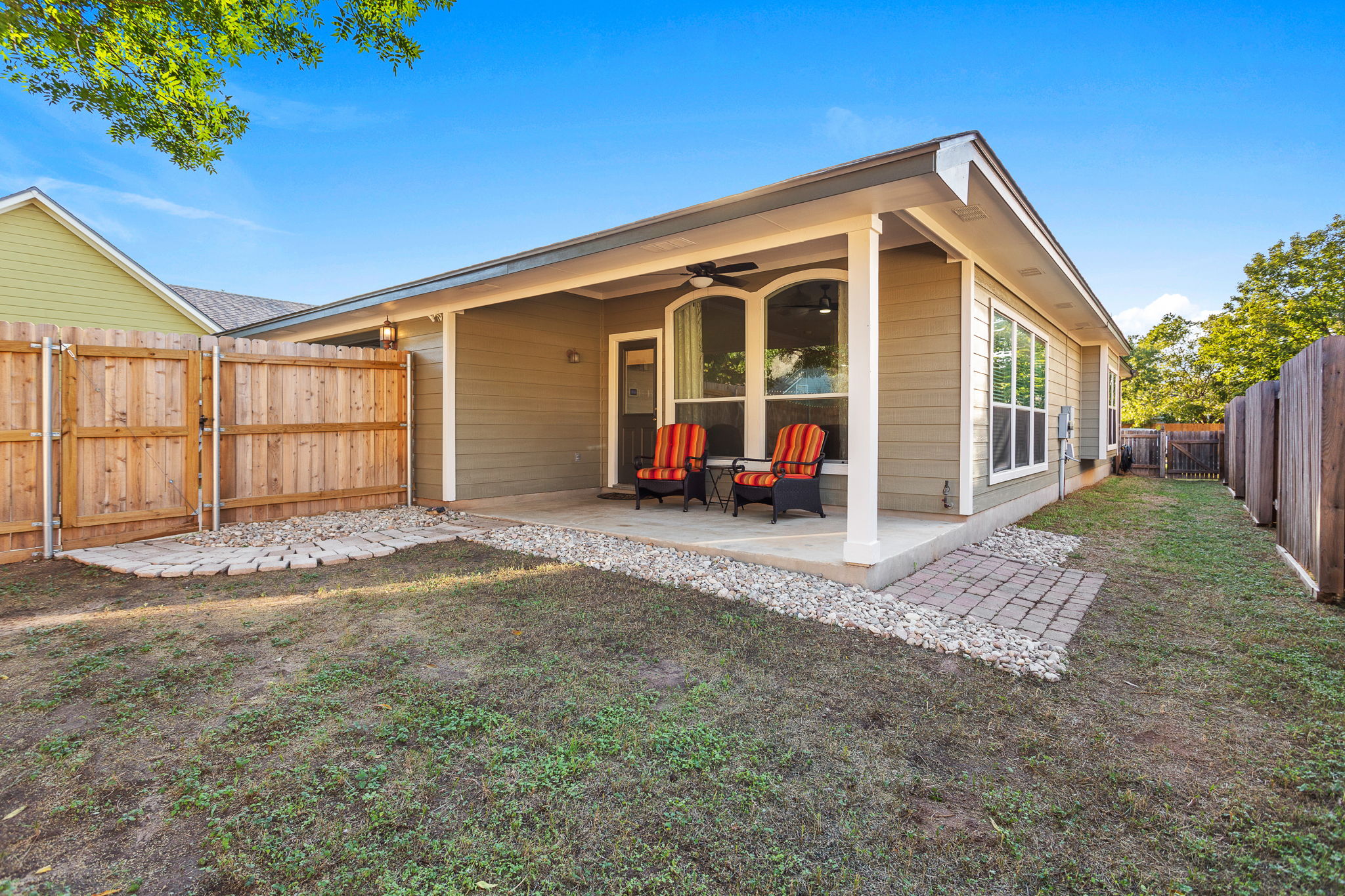313 Greenside Lane Georgetown, TX 78633 - Photo 10 of 40 Back of house with ceiling fan, a fenced backyard, and a gate