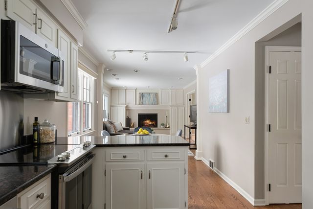 a living room with fireplace furniture and a window