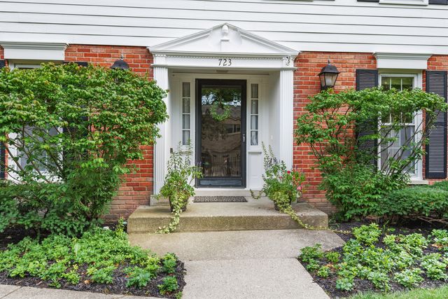front view of a house with potted plants