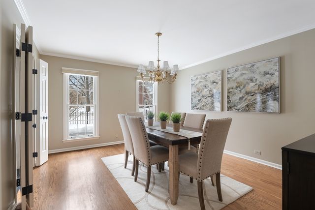 a dining room with furniture and wooden floor