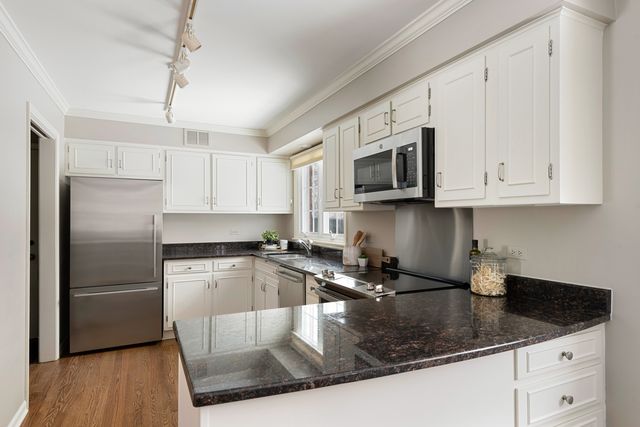 a kitchen with white cabinets and a sink