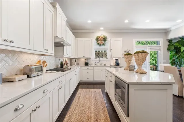 a kitchen with a sink microwave and cabinets