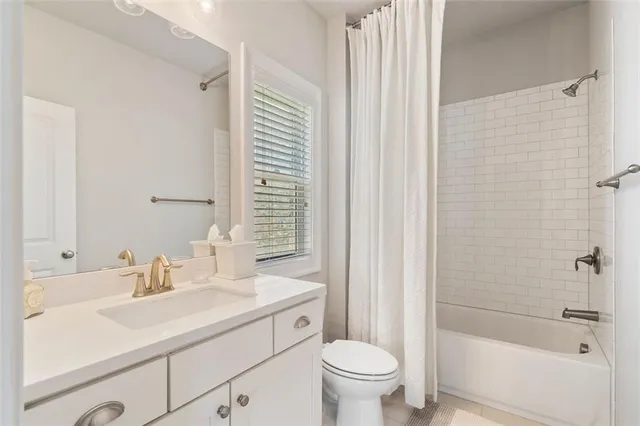 a living room with furniture a large window with kitchen view