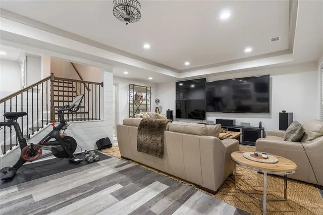 a living room with fireplace furniture and a flat screen tv