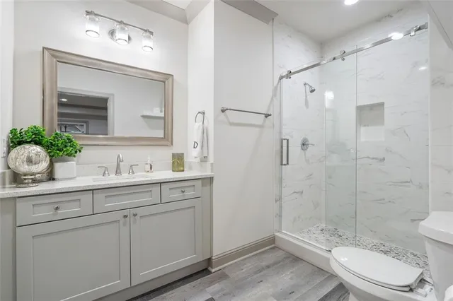 a kitchen with a sink a refrigerator and chairs