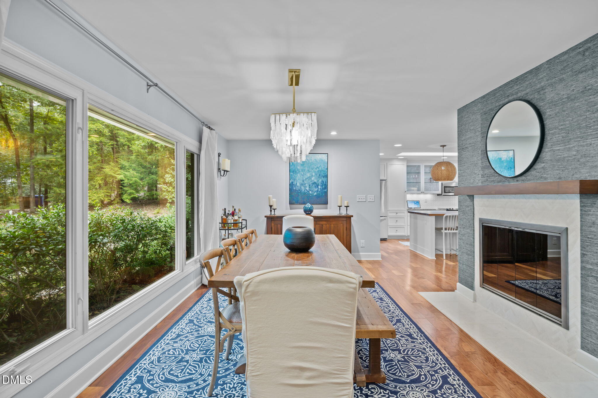 1812 Rolling Road Chapel Hill, NC 27514 - Photo 12 of 72 a living room with furniture a chandelier and a fireplace