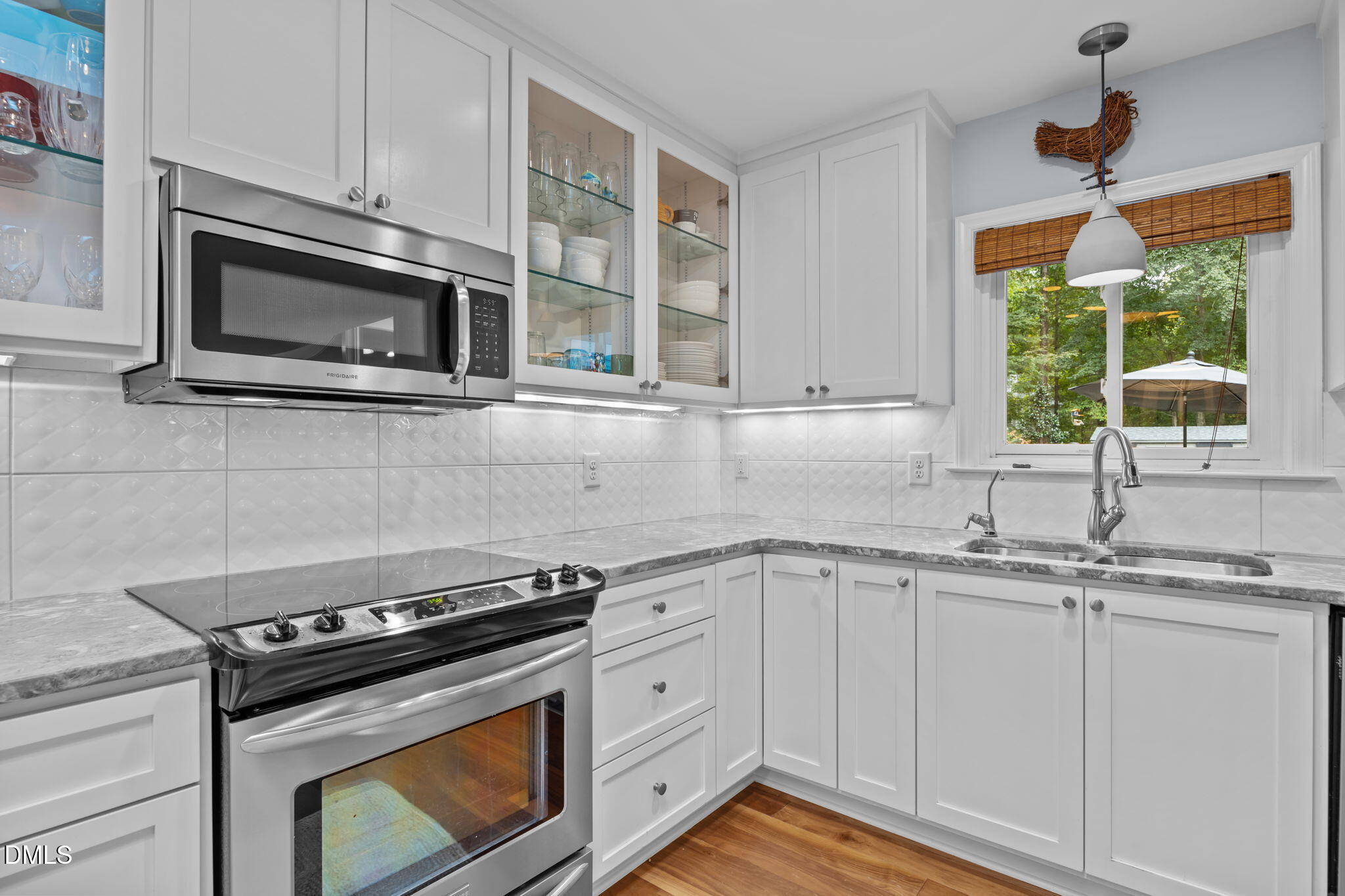 1812 Rolling Road Chapel Hill, NC 27514 - Photo 20 of 72 a kitchen with stainless steel appliances granite countertop white cabinets and a stove top oven