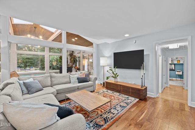 a bedroom with bed and a chandelier