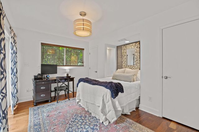 a bedroom with a bed and a chair