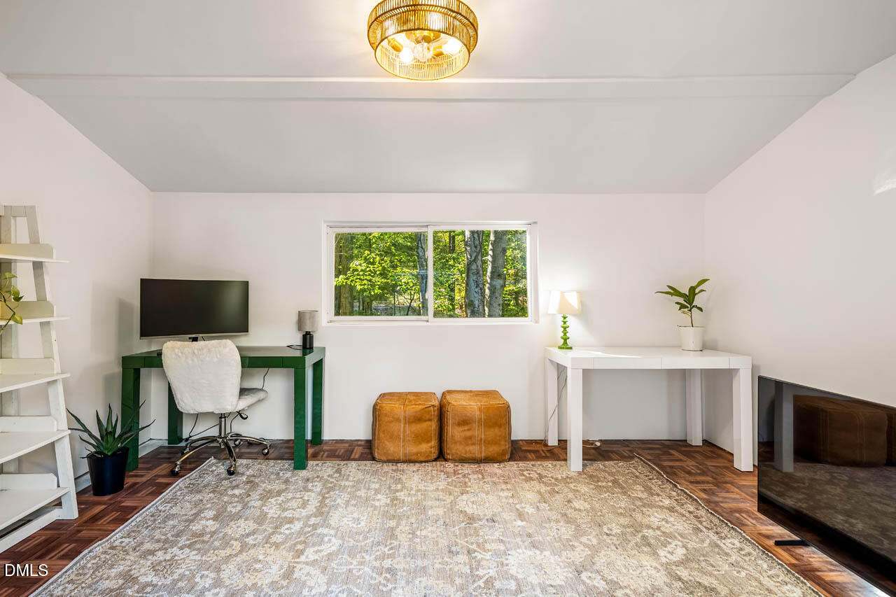 1812 Rolling Road Chapel Hill, NC 27514 - Photo 44 of 72 a living room with a couch and a flat screen tv