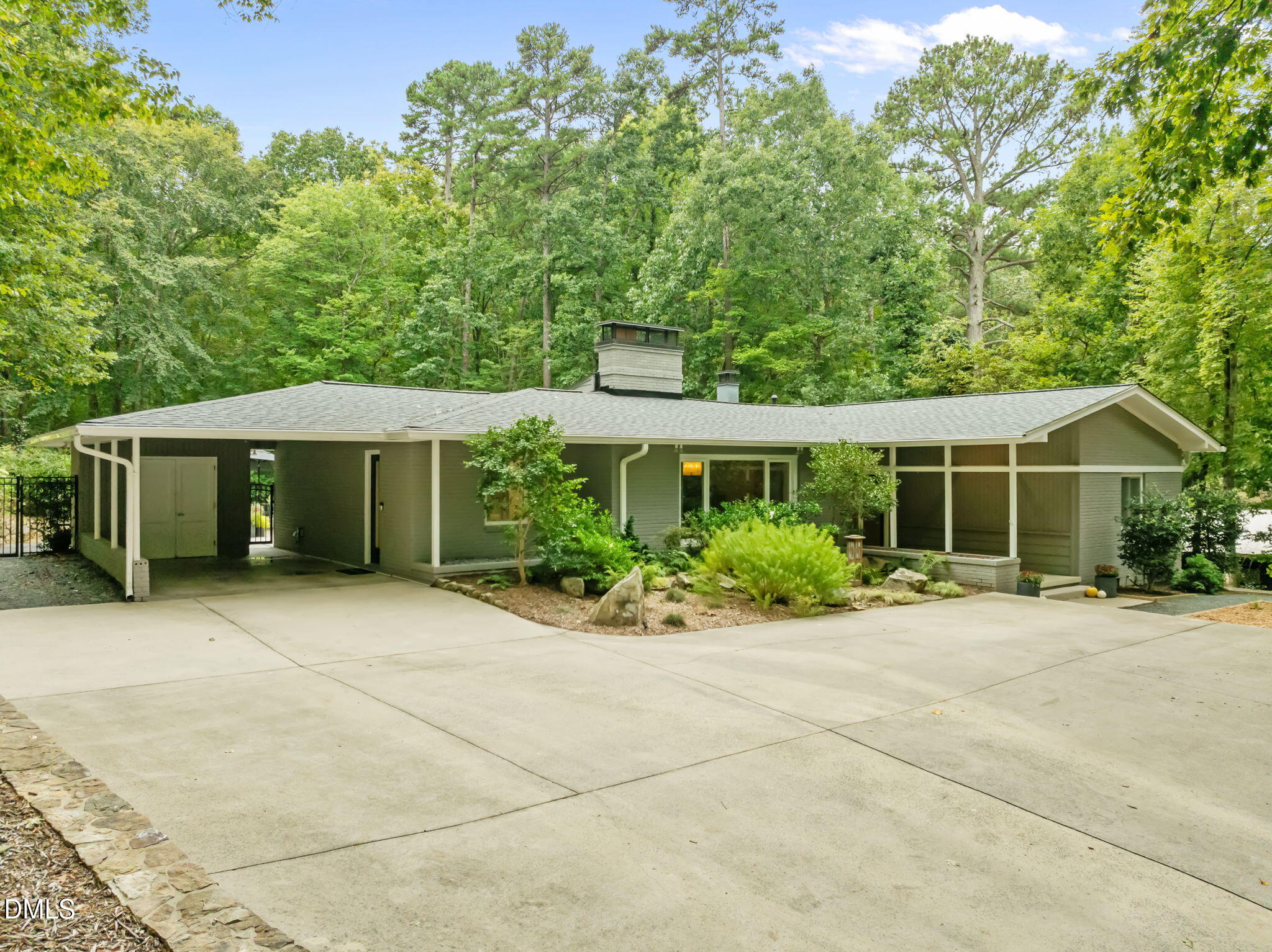 1812 Rolling Road Chapel Hill, NC 27514 - Photo 55 of 72 a front view of a house with a yard and potted plants