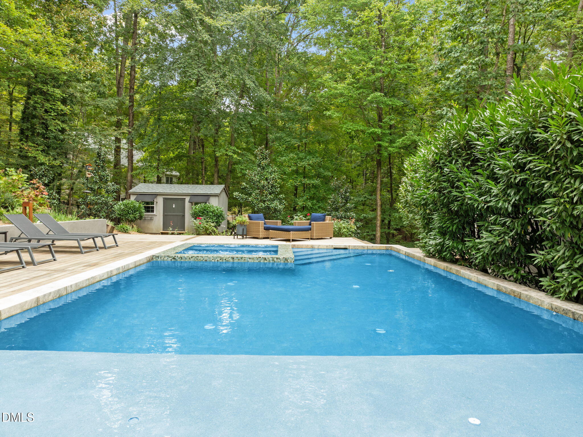 1812 Rolling Road Chapel Hill, NC 27514 - Photo 5 of 72 a view of a swimming pool with a lounge chair