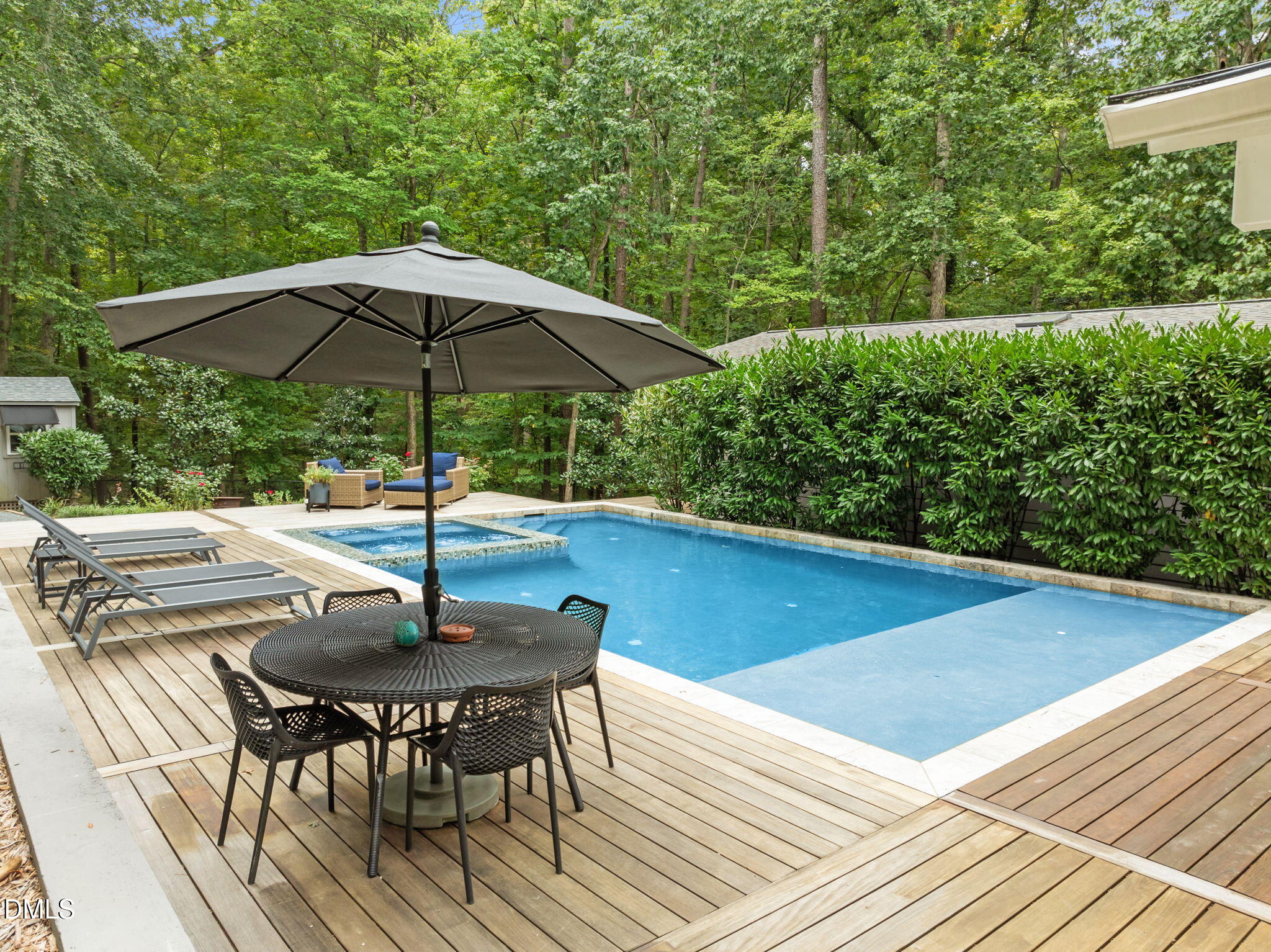 1812 Rolling Road Chapel Hill, NC 27514 - Photo 6 of 72 a view of a patio with a table and chairs under an umbrella