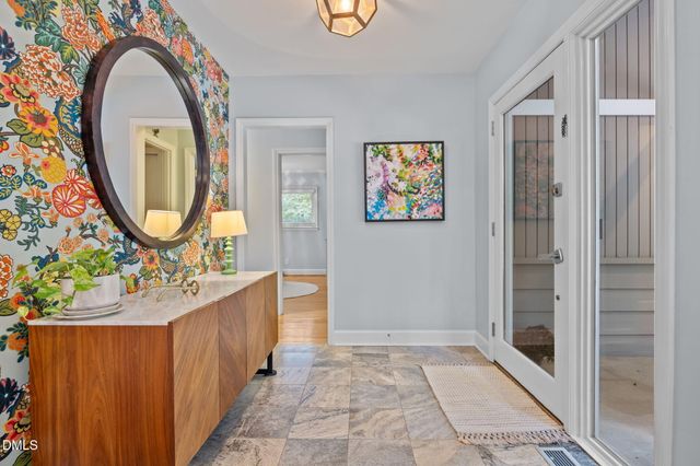 a bathroom with a sink mirror and vanity