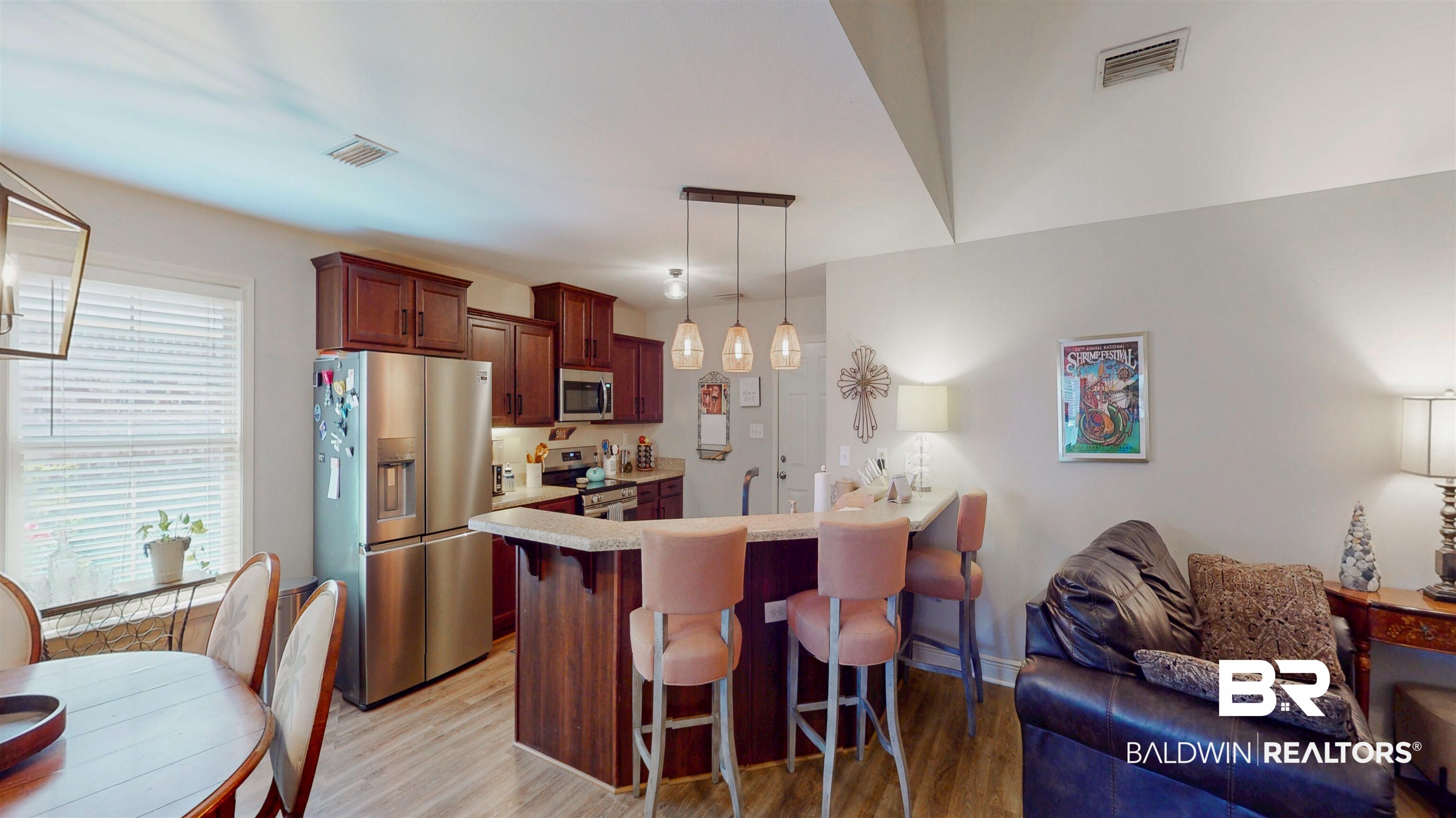 1304 Majesty Loop Foley, AL 36535 - Photo 6 of 44 Kitchen with a breakfast bar area, stainless steel appliances, a peninsula, light wood-style flooring, and pendant lighting