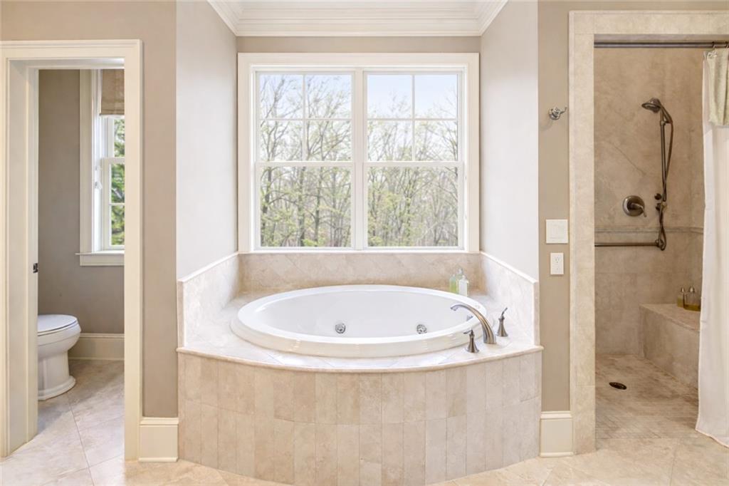 1005 Heards Ferry Road Northwest Sandy Springs, GA 30328 - Photo 21 of 30 a white bath tub sitting next to a toilet