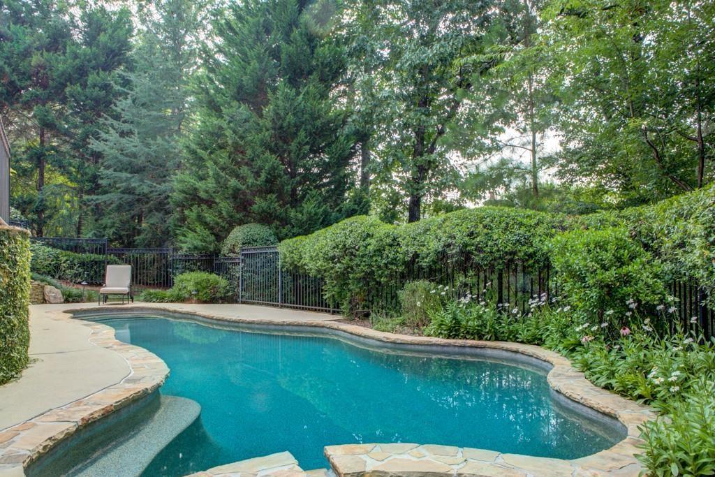 1005 Heards Ferry Road Northwest Sandy Springs, GA 30328 - Photo 27 of 30 a view of backyard with swimming pool