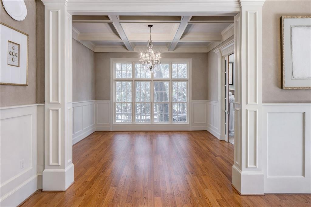 1005 Heards Ferry Road Northwest Sandy Springs, GA 30328 - Photo 9 of 30 a view of an empty room with wooden floor and a window
