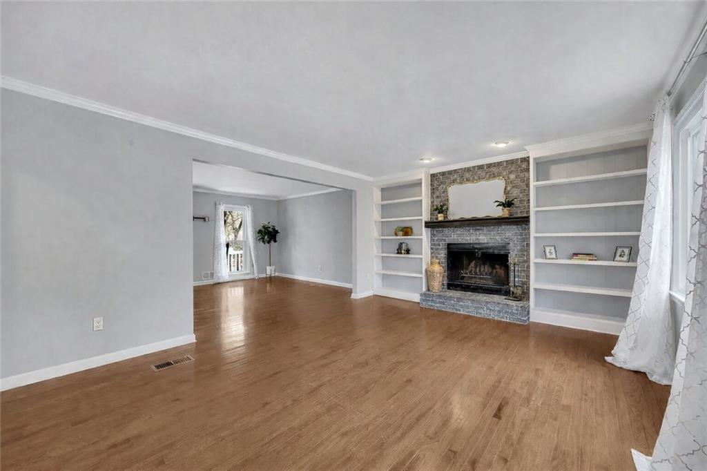 507 Spring Creek Way Northeast Marietta, GA 30068 - Photo 12 of 50 a view of empty room with wooden floor and fireplace