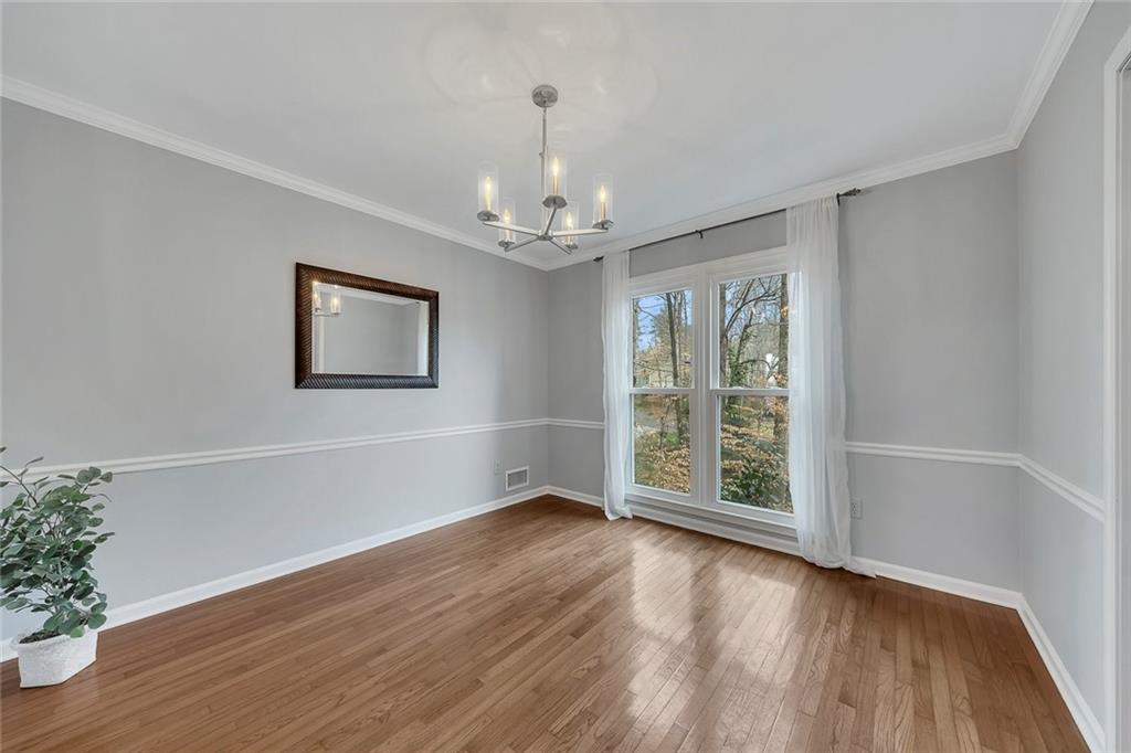 507 Spring Creek Way Northeast Marietta, GA 30068 - Photo 14 of 50 a view of an empty room with wooden floor and a window