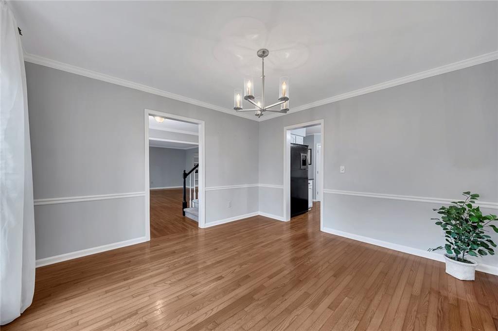 507 Spring Creek Way Northeast Marietta, GA 30068 - Photo 15 of 50 wooden floor in an empty room with a window
