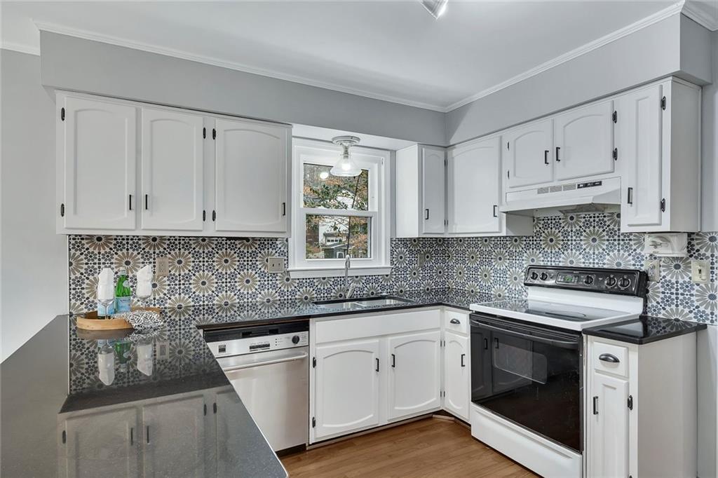 507 Spring Creek Way Northeast Marietta, GA 30068 - Photo 16 of 50 a kitchen with white cabinets appliances and a sink