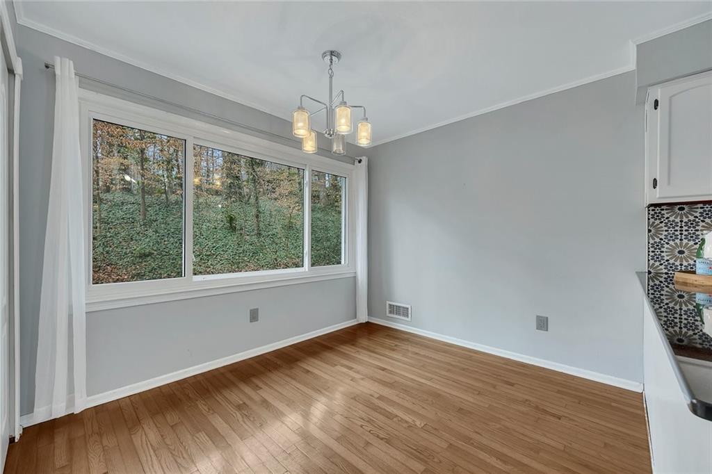 507 Spring Creek Way Northeast Marietta, GA 30068 - Photo 19 of 50 a view of empty room with wooden floor and fan