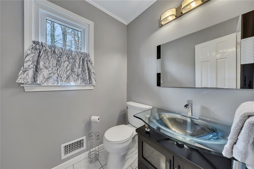 507 Spring Creek Way Northeast Marietta, GA 30068 - Photo 20 of 50 a bathroom with a granite countertop toilet sink and mirror