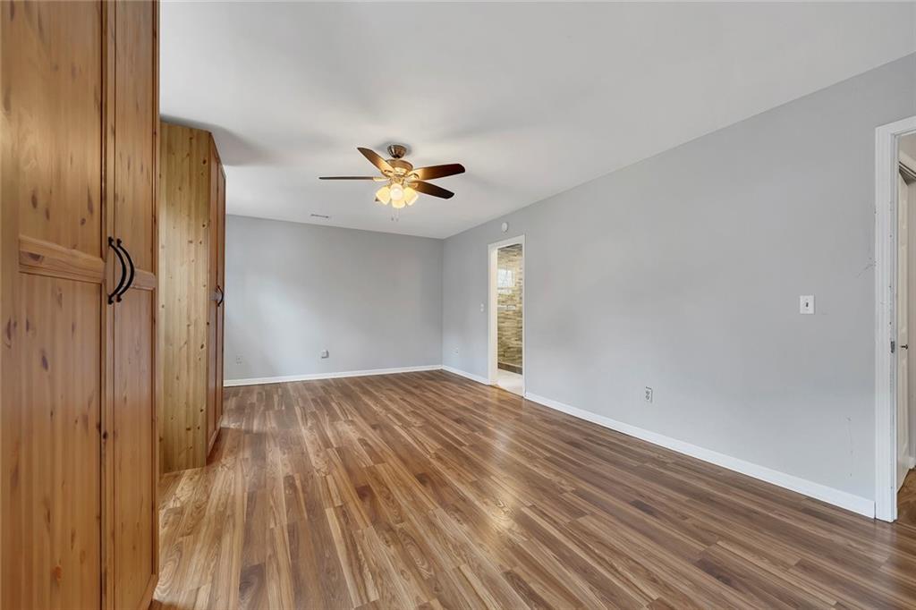 507 Spring Creek Way Northeast Marietta, GA 30068 - Photo 23 of 50 a view of an empty room with wooden floor and a window