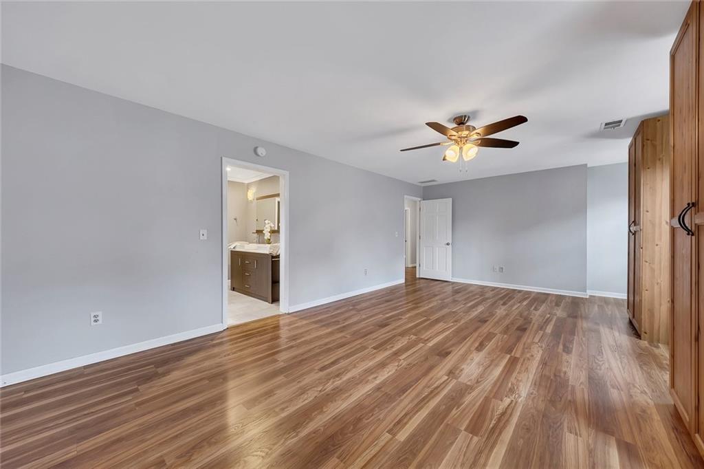 507 Spring Creek Way Northeast Marietta, GA 30068 - Photo 24 of 50 a view of an empty room with a window and wooden floor