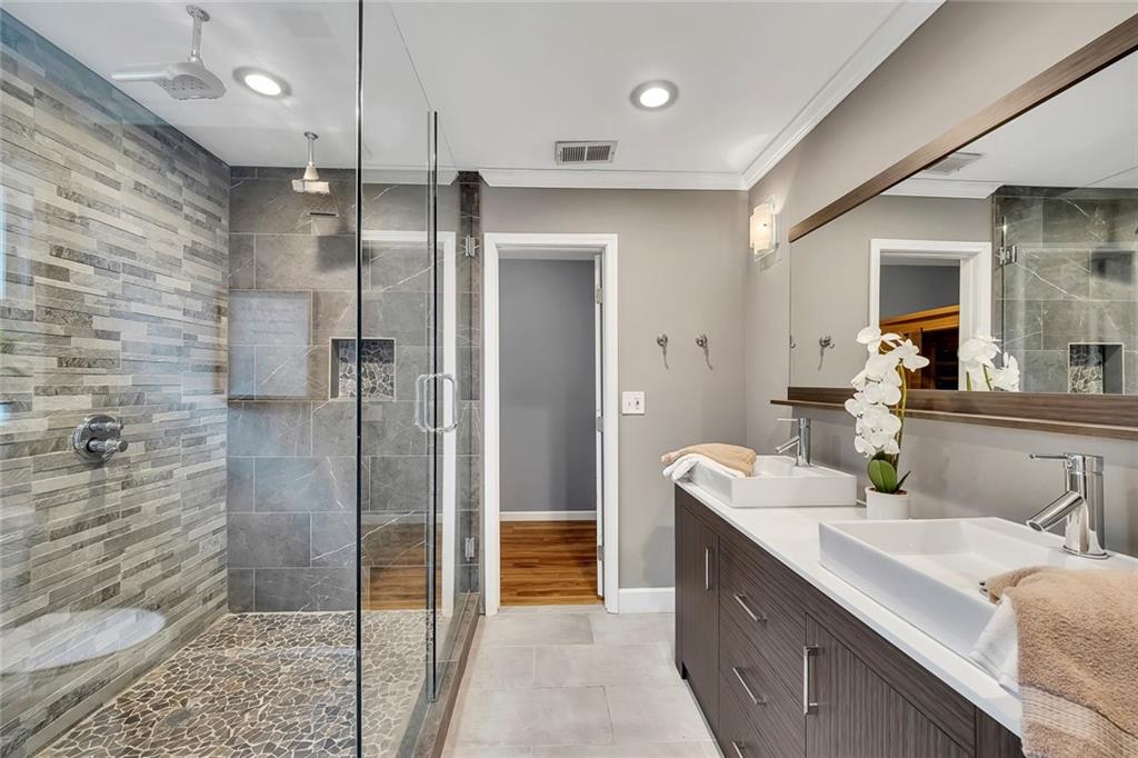 507 Spring Creek Way Northeast Marietta, GA 30068 - Photo 25 of 50 a bathroom with a double vanity sink mirror and shower